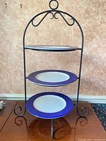 front view of wrought iron stand with three plates