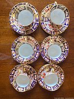 Six Imari cups nested on saucers top view