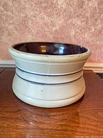 Front view showing beige exterior with blue bands