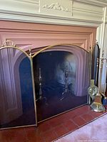 Full view of brass fireplace screen, andirons, and tool set