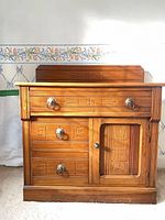Front view of cabinet showing drawers, door, backsplash