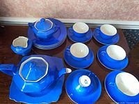 Full set layout showing all blue pieces including teapot, sugar, creamer, cups, saucers, plates