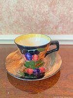 Front view of teacup on saucer displaying hand-painted design