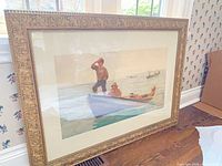 Full view of framed print leaning against wall