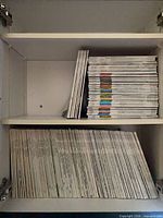 Two shelves filled with vertical and horizontal stacks of Bon Appétit magazines