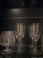 Snifter and two tall stemmed glasses with matching etched pattern