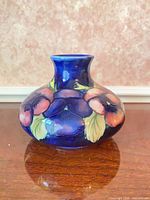 Front view of Moorcroft squat vase showing pansy design