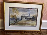 Front view of one framed watercolour showing barn scene with tree and gold frame