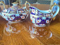 Sugar dish and creamer showing pattern and overall condition