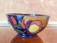 Side view showing floral motif and glossy finish