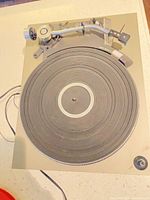 Top view of Technics turntable showing tonearm, platter and wires
