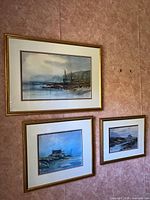 All three framed watercolours hanging on wall