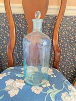 Full view of Grasselli Chemical Co. glass bottle with stopper