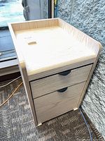 Front view of light wood 2-drawer filing cabinet
