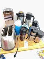 Group overview showing toaster, carafes, travel mugs, water bottle, and Zojirushi box