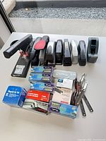 Overall lot showing staplers, staple boxes and removers