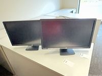 Front view of two HP 23" monitors on stands