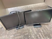 Both HP monitors side by side with cord