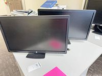 Front view of two HP E231 monitors on stands