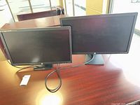 Both HP E231i monitors on desk, front view