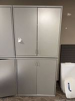 Front view of stacked light gray steel cabinets