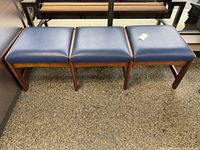Full view of three-seat bench, blue vinyl cushions, wood frame
