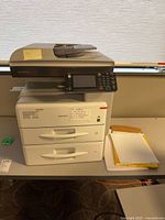 Front view showing Ricoh MP 301 printer with dual paper trays and control panel