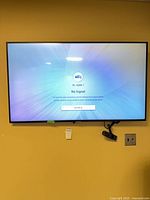 Front view of Samsung TV on wall displaying No Signal screen