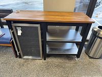 Front view of trolley showing wood top, metal frame and shelves