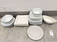 Stacks of square and round plates, bowls, gravy boat