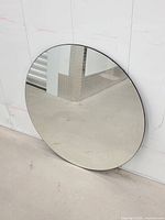 Front view of round mirror showing reflective surface and edge