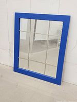 Front view of blue frame window pane mirror