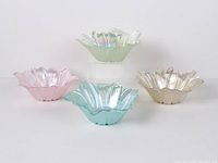 Four pastel frosted glass tulip bowls, angled side view