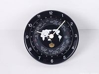 Front view of black CMC world time wall clock