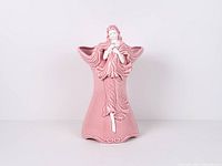 Front view of pink ceramic vase with raised lady figure