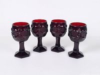 Four ruby red Avon Cape Cod wine goblets front view