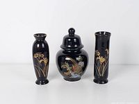 Front view of ginger jar flanked by two vases