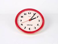 Front view of entire Westclox wall clock showing red bezel and white dial