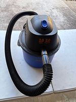 Front view of Kobalt 2-gallon wet/dry vacuum with hose coiled around body