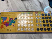 Open album showing filled 1999-2003 quarter slots and empty 2004-2008 slots