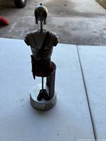 Front view of figurine showing armor detail and inscription "Put on the full armor of God" on base