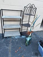 Both shelving units and floor vase displayed together