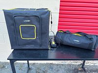 Litebox folded cube, carry bag, AC adapter on table