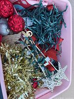 Top view showing ornaments, lights, tinsel, star tree-topper