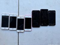 Front view of six devices showing cracked screens and sizes