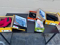 Table overview showing five boxed women’s dress shoes