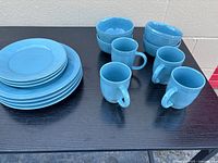Full set on table showing plates, bowls and mugs