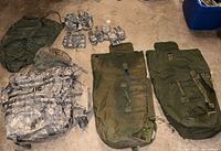 All items laid out: rucksack, two clothing bags, seven pouches
