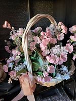 Overall view of wicker basket floral arrangement with pink and white flowers, ribbon bow and heart pick