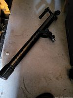 Bushnell black refractor OTA on floor showing full length and focuser